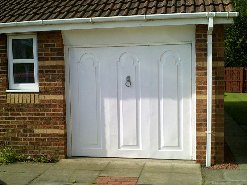 White Seceuroglide Remote Control Insulated Roller door (Before)