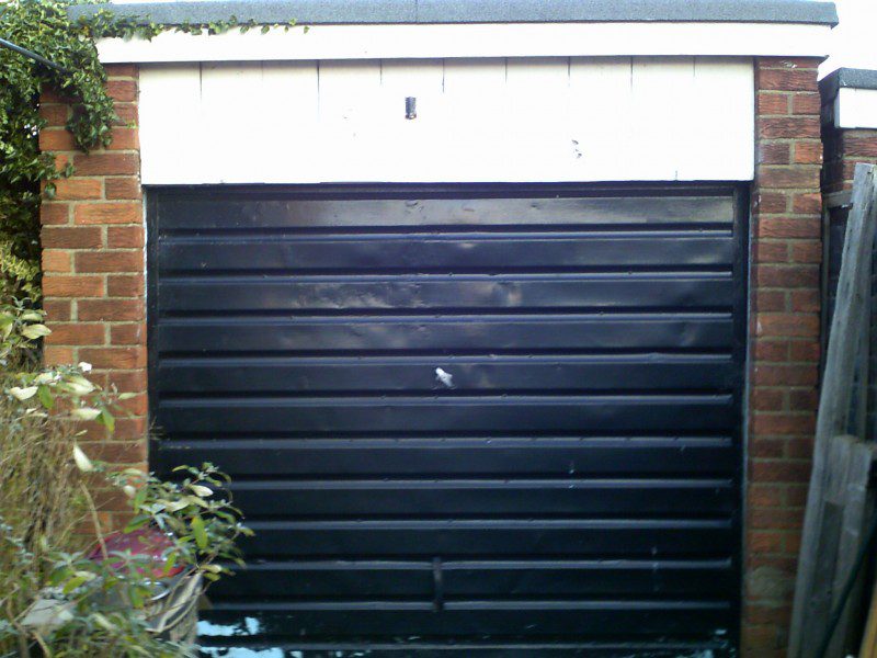 White Horizontal Rib Style Up and Over Garage Door (Before)