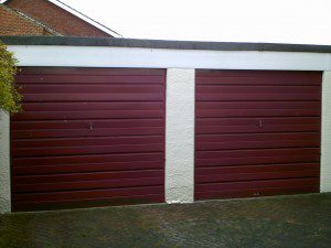 Red Woodgrain Sectional Garage Door (Before)